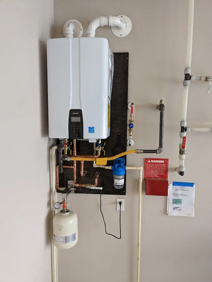 Professional plumber installing copper piping in a Charlestown home